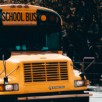 A school bus drives on a city street
