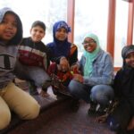 Five Rising Star students sit together and smile for a photo