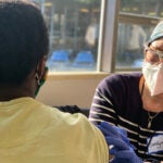 A healthcare worker provides a vaccine to a patient