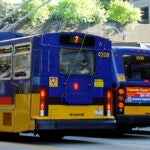 Two metro buses on the city street.