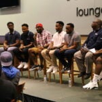 A group of students and mentors in a panel discussion