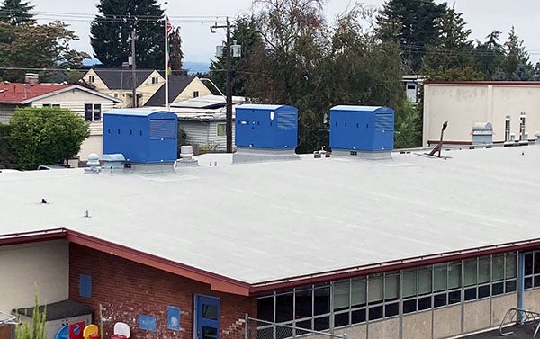 blue boxes sit on a flat roof