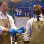 The mayor and superintendent get ready to serve lunch to students