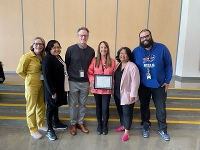 counselor of the year, Carley Spitzer, holding her award