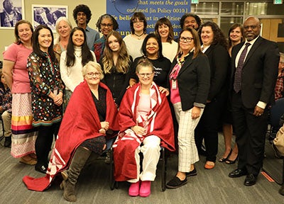 The school board and staff gather together for a photo at the blanket ceremony