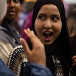 Surprised student smiles with mouth wide open after receiving scholarship.