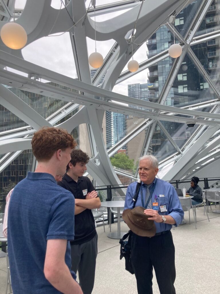 teacher and students smiling in geodesic dome