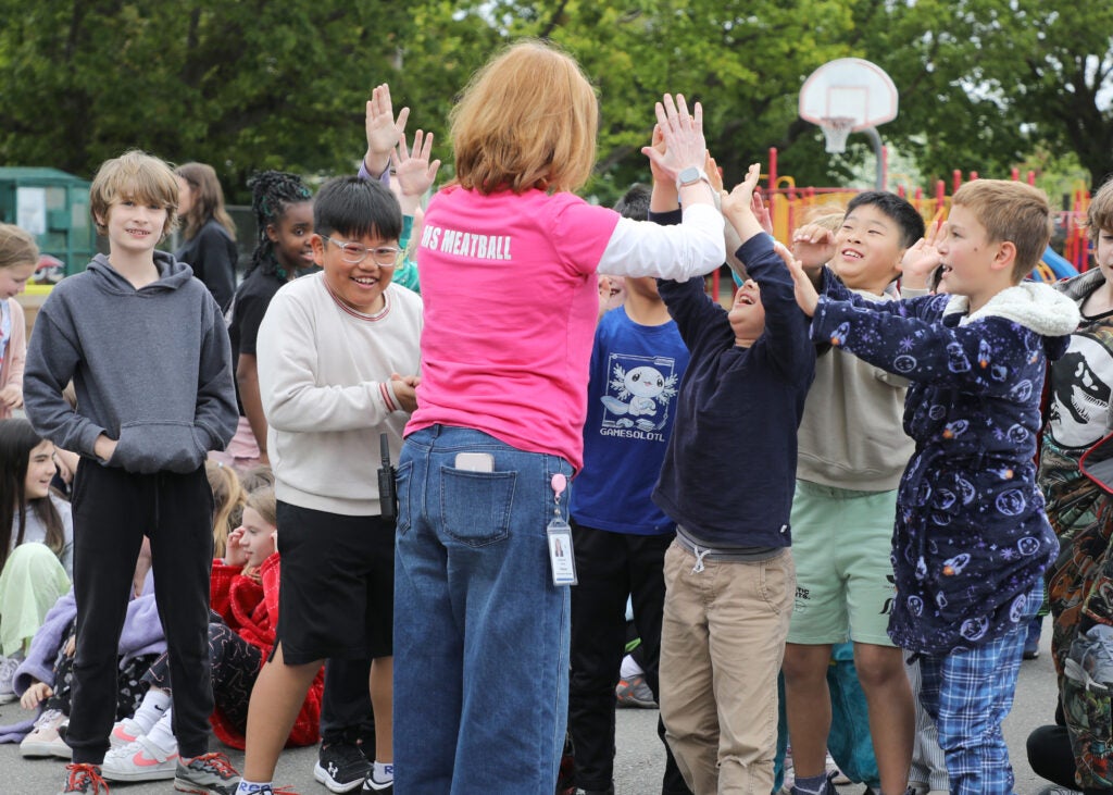 All Star Deidre Palmer high fives students