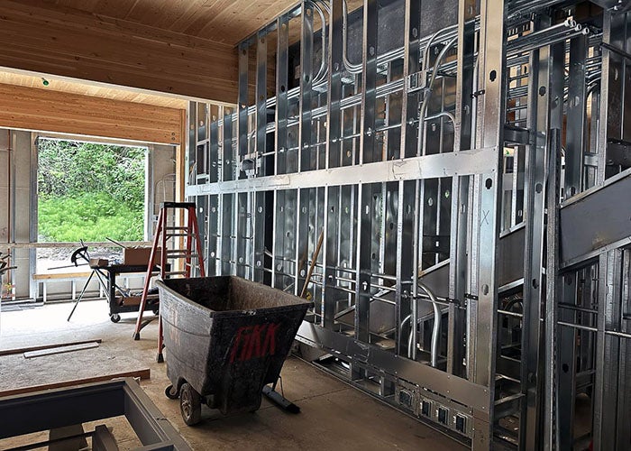 a metal framed wall with wood beams and ceiling