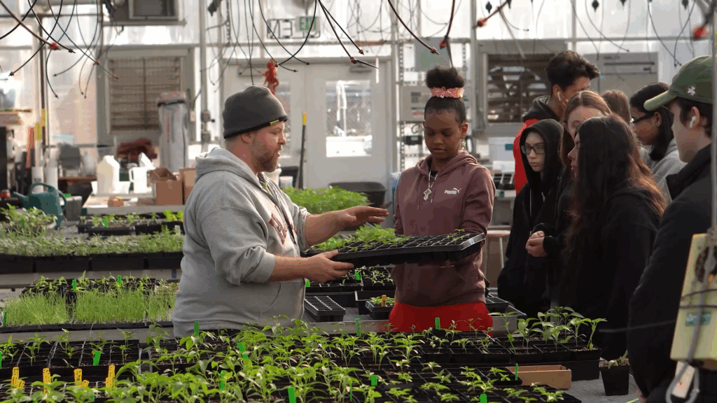 student and teacher working in greenhouse
