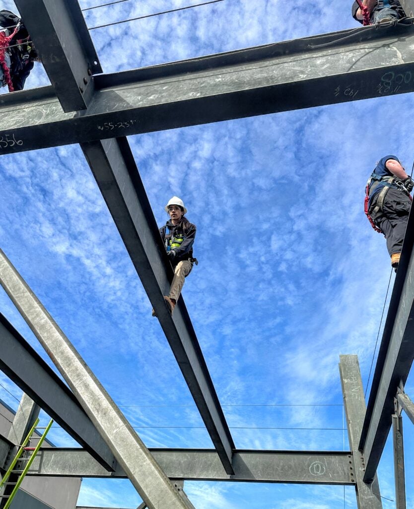 student climbing steel bar in pre-apprenticeship class