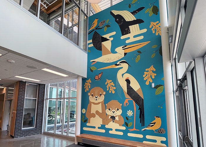 a mural on the wall of a two-floor entry