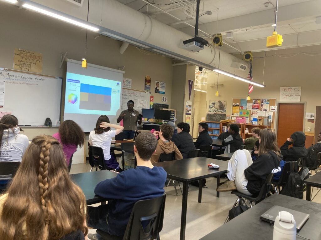 students in classroom viewing heavily pixelated image