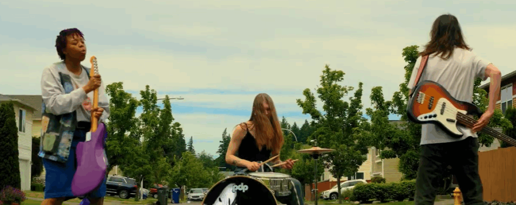 still from a film of students playing music in the street