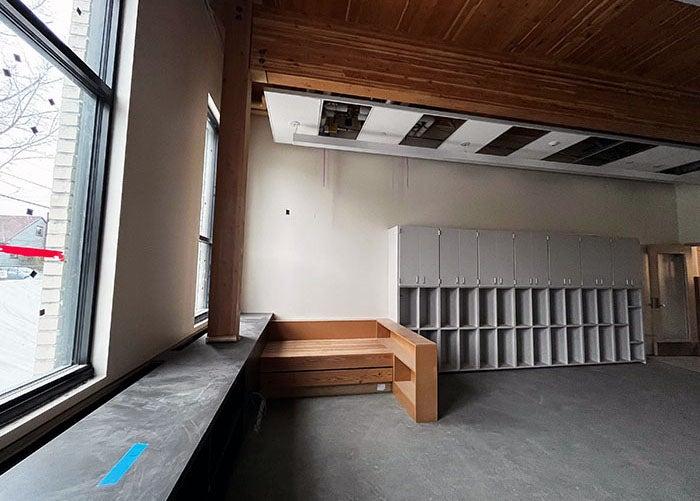 partial view of a classroom in progress with a wood ceiling, wide window ledge, and cabinets