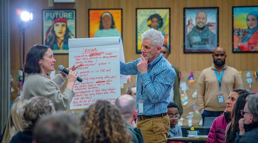 Community members presenting at a Superintendent community meeting in the Salmon Bay Cafeteria