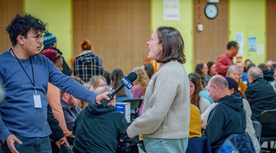 Community member speaking at a Superintendent community meeting in the Salmon Bay Cafeteria