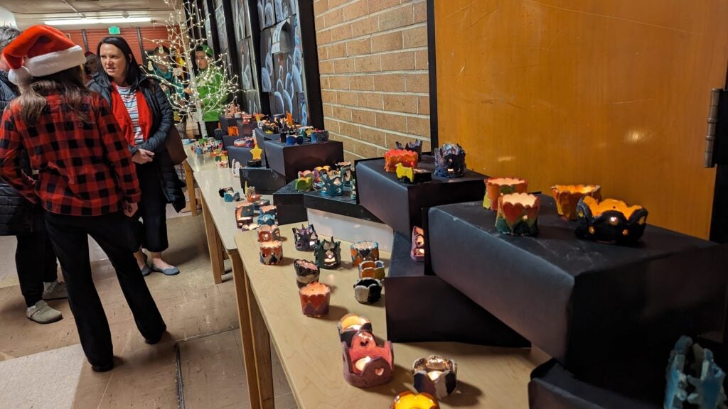 Hallway with Families and Tables with Clay Artwork.