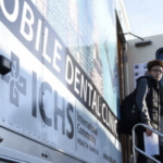 Mobile Dentist Bus with student on stairs