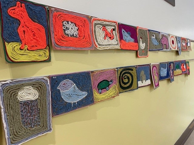 Hallway view of Huichol Native Mexican yarn art Concentric.