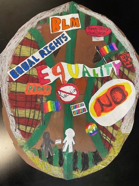 mixed media on shield shape with text related to BLM