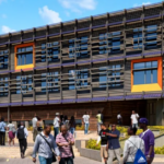 architects drawing of the front of a school with students walking