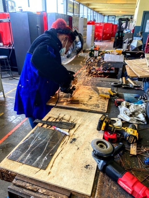 Student cutting metal