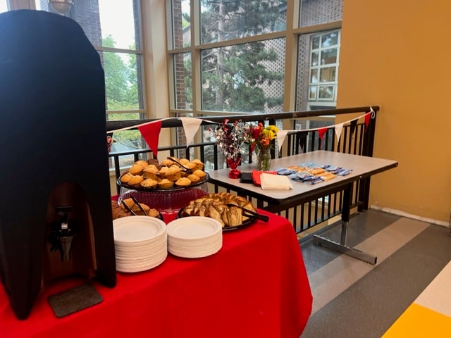 Tables in the hallway welcoming back staff with lunch items.