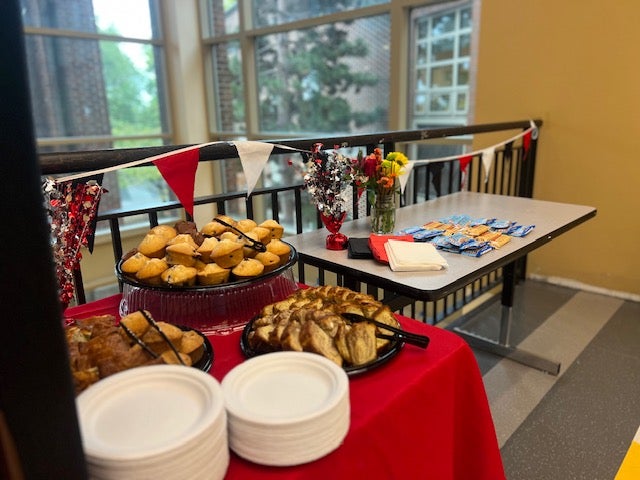 Tables in the hallway welcoming back staff with lunch items.