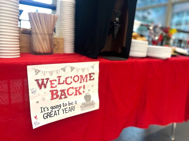 Tables in the hallway welcoming back staff with lunch items.