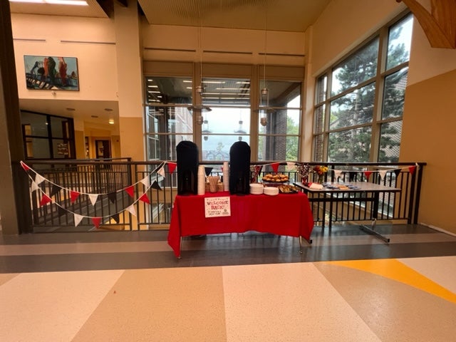 Tables in the hallway welcoming back staff with lunch items.