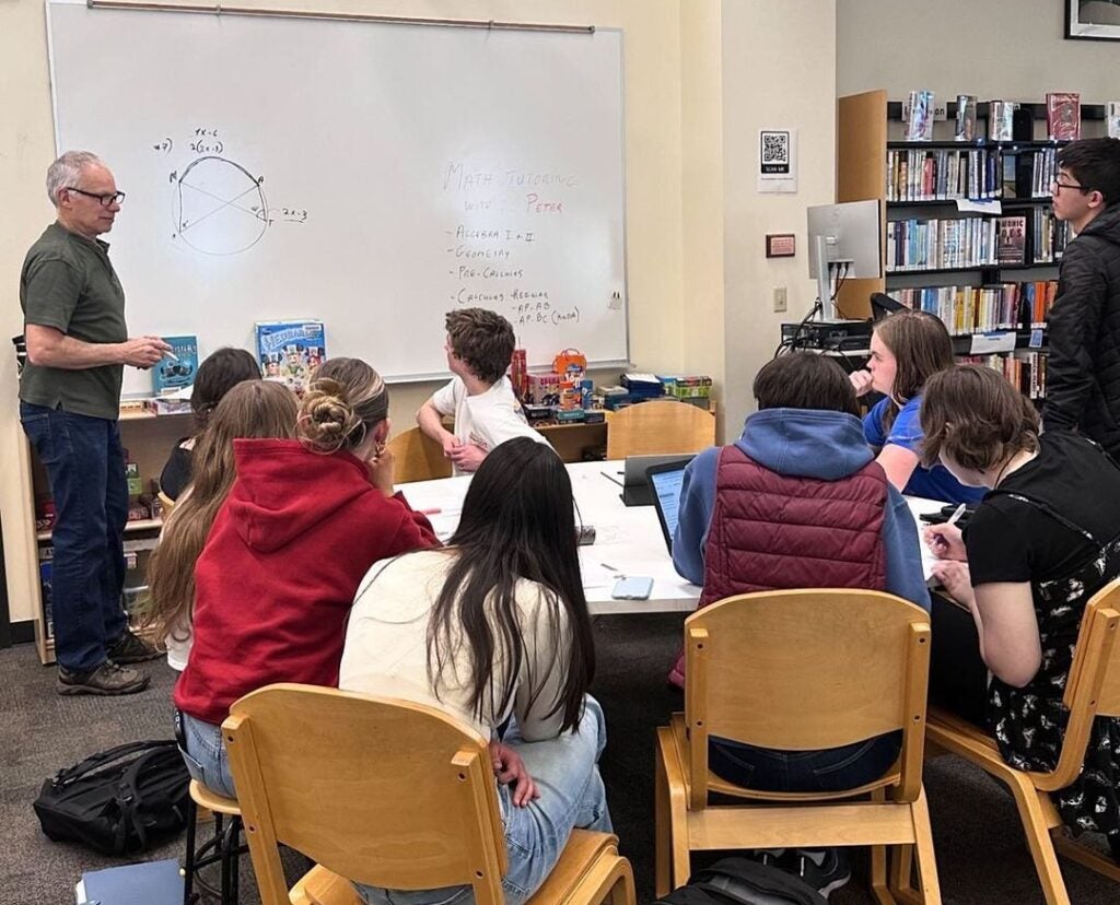 Students and Math Tutor in Library