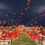 Caps in Air At Graduation on Memorial Field.