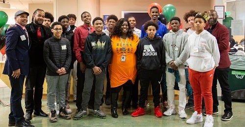 A group photo of students and staff during the orientation.