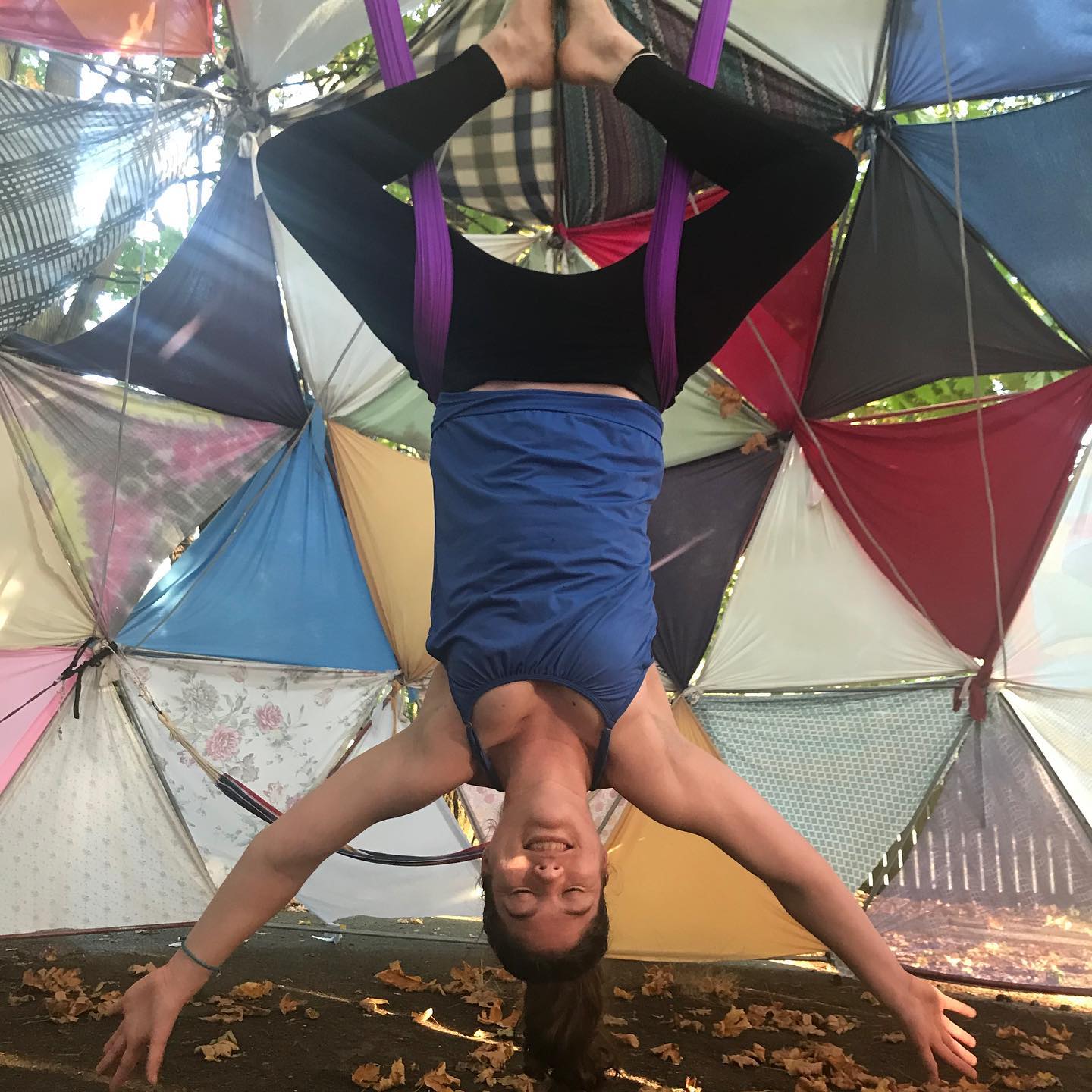 Photo of teacher hanging upside-down doing yoga