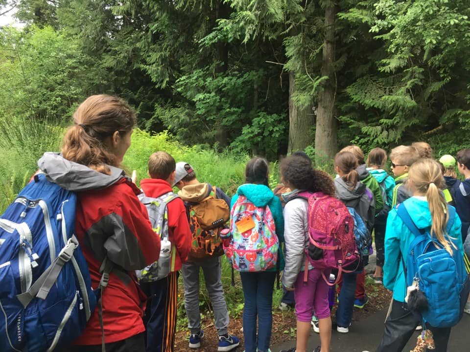 Photo of students on trail with backpacks