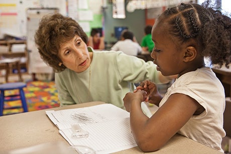 student reading to an adult