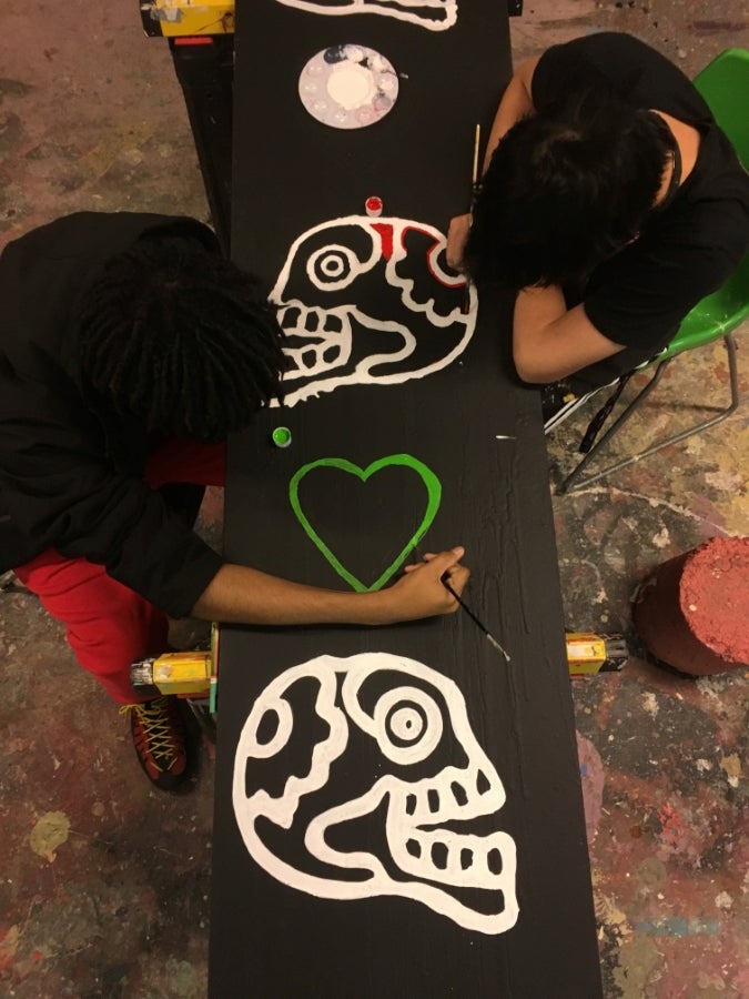 White skulls painted on black board