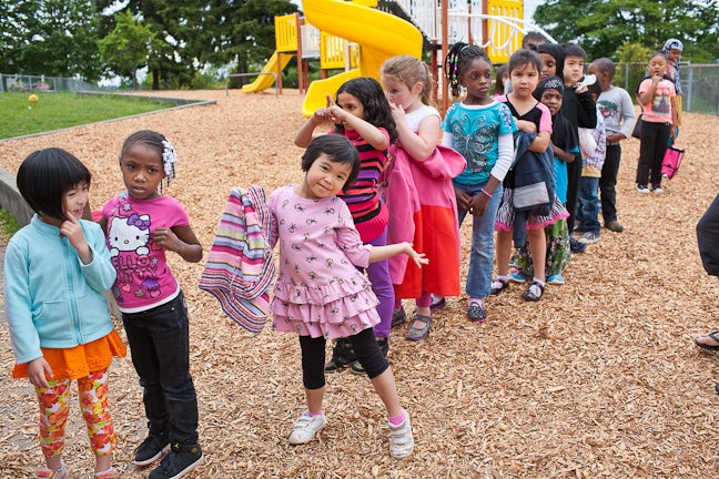 Kids lining up on a playground to go in to class