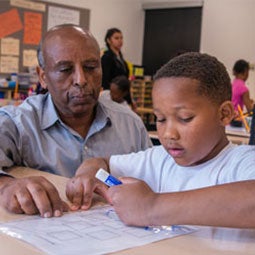 A student and teacher work together in a classroom
