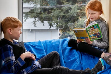 Two students read together.