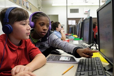 Two students work together at a computer