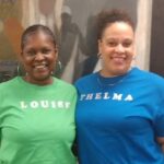 two ladies in blue green shirts