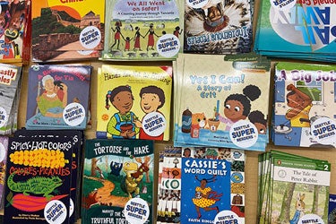 A selection of early reader books on a table.