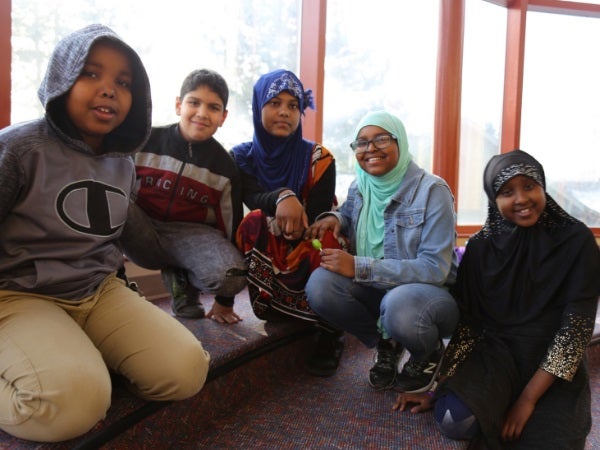 Five Rising Star students sit together and smile for a photo