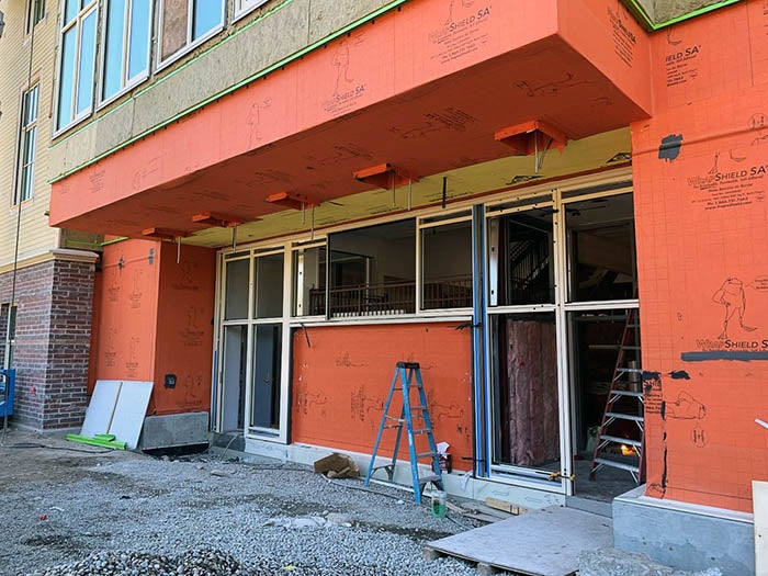 first floor of a building under construction with orange material on outside