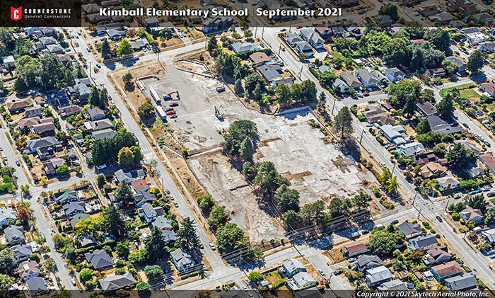 aerial photo of a neighborhood with an empty block sized lot