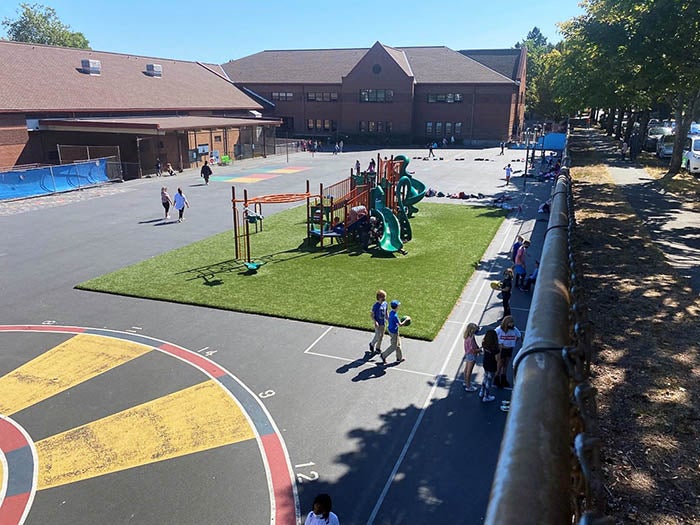 a playground with a play structure and children