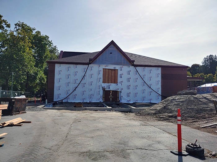 a building with a wall removed and Tyvek sheathing installed