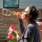 Photo of Debi Thomas-Jones blowing bubbles